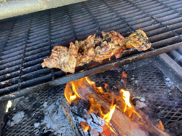 BBQ meat grilling over open flame at Pig-O-Latte’s food truck in Grants Pass Oregon